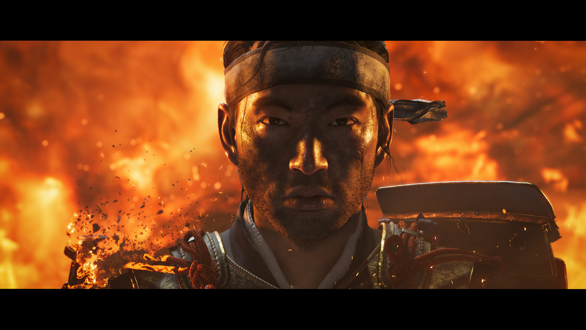 Jin Sakai with fire behind him